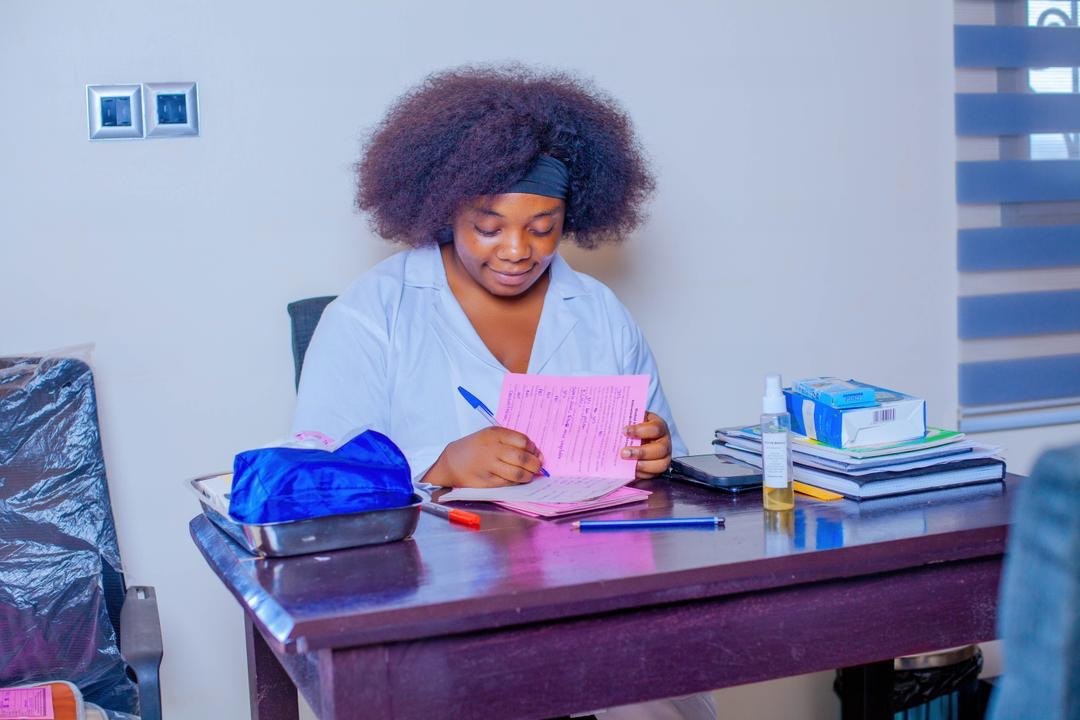 S19 staff recording patient health records at the clinic office